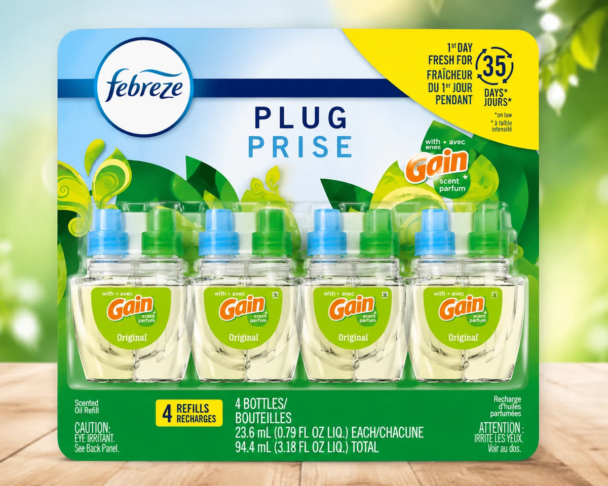 A package of four Febreze Plug Prise dish cleaner refill bottles with Gain Original liquid, shown in a retail blister pack against a blurred green and yellow background.
