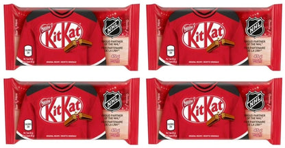 Four packaged KitKat chocolate bars arranged in a 2x2 grid. Each package is shaped like a red hockey jersey with black trim, a KitKat logo, and an NHL shield logo on the front.