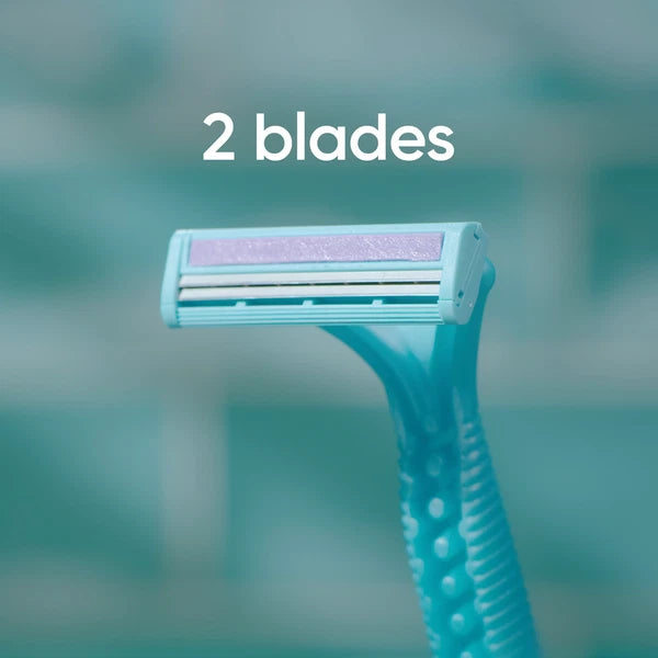 Turquoise razor with two blades on a blurred green background